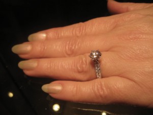 White gold engagement ring with pave-set side stones, milgrain edging, 6-prong setting
